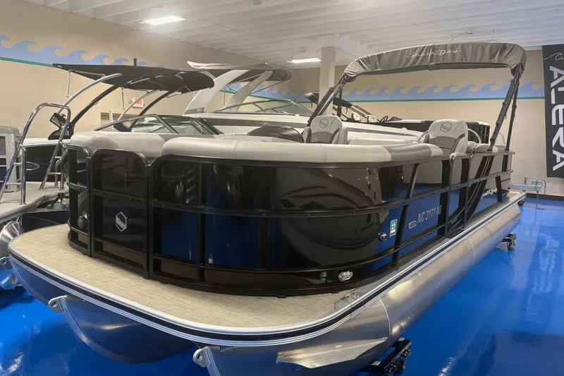 The Image of 2022 South Bay 224 RS 3.0 pontoon boat displayed indoors on blue flooring. - 0