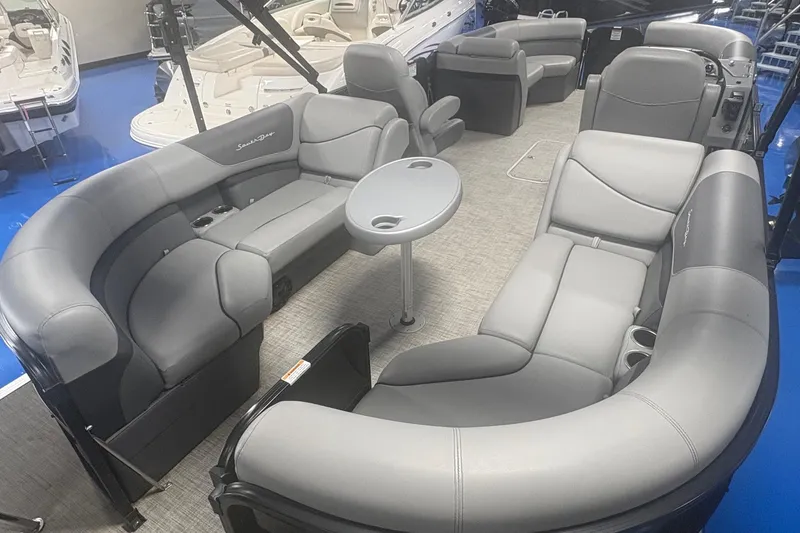 Slide: The Image of Luxurious 2022 South Bay 224 RS 3.0 pontoon boat interior with plush seating and table. - 3