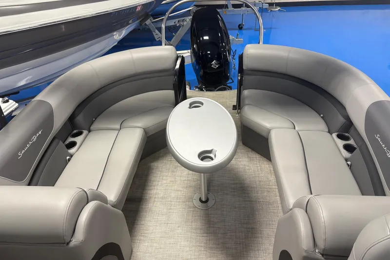 Slide: The Image of 2022 South Bay 224 RS 3.0 boat interior with gray seating and central table. - 8