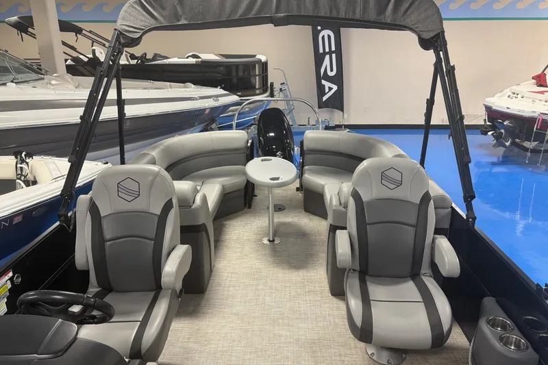 Slide: The Image of Interior of 2022 South Bay 224 RS 3.0 pontoon boat with gray seating and table. - 9