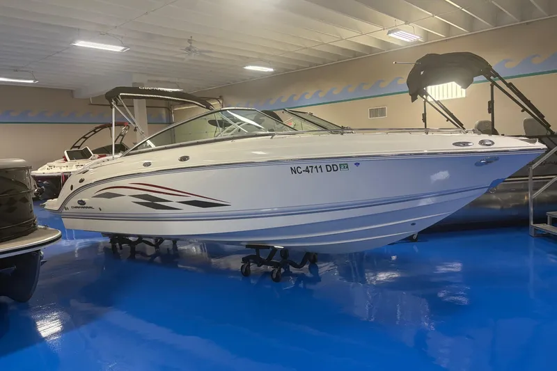 The Image of 2005 Chaparral 236 SSi boat displayed indoors on a blue floor. - 0