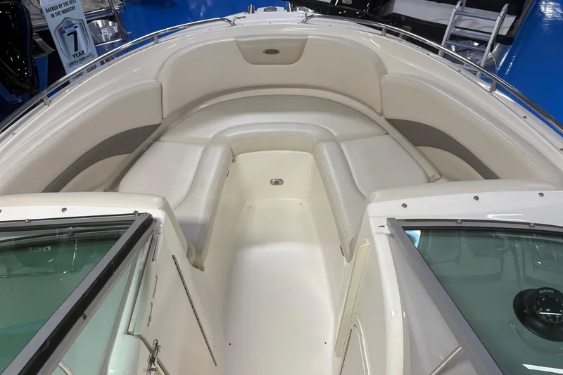 Slide: The Image of 2005 Chaparral 236 SSi boat interior with beige seating and open windshield. - 3