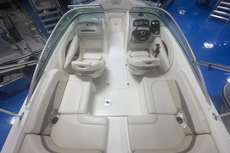 Slide: The Image of 2005 Chaparral 236 SSi boat interior with white seating and steering console. - 4