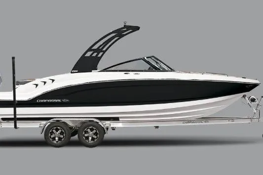 Slide: The Image of 2026 Chaparral 23 SSi OB boat on trailer, parked outside marine supply store. - 1