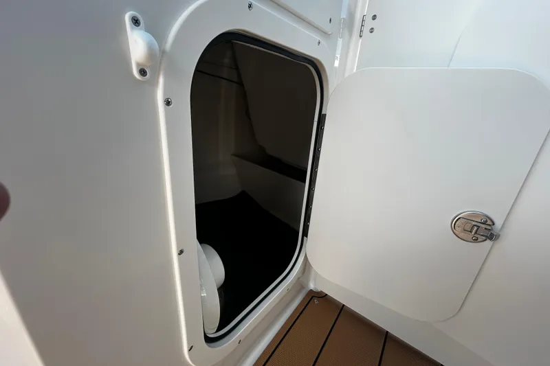 Slide: The Image of 2026 Chaparral 23 SSi OB boat cabin entrance with open door and secure latch. - 12