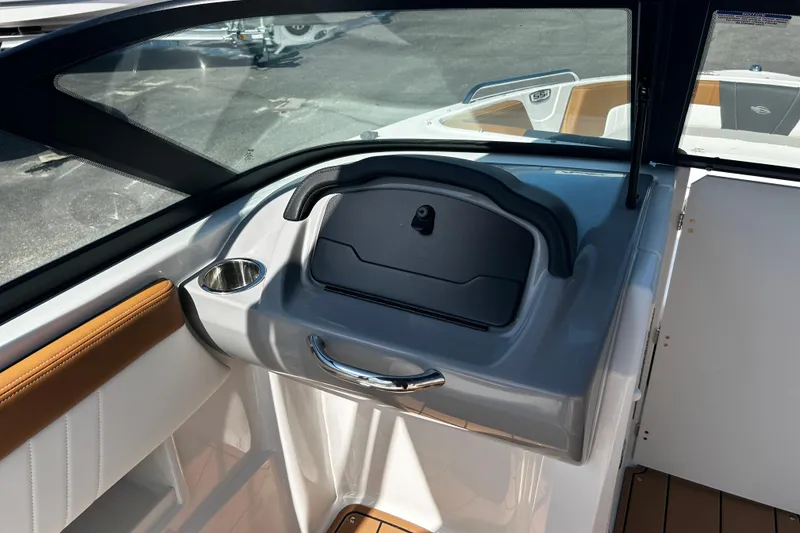 Slide: The Image of 2026 Chaparral 23 SSi OB boat interior with glove compartment and cup holder. - 16
