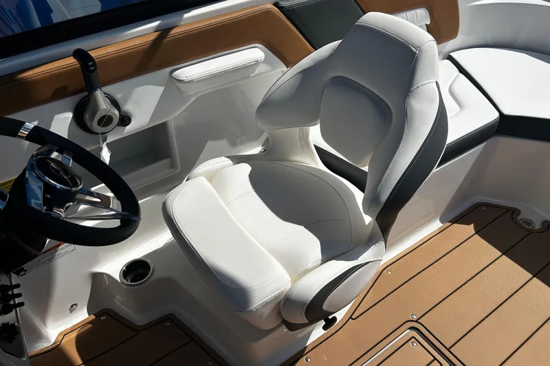 Slide: The Image of 2026 Chaparral 23 SSi OB boat interior with white captain's chair and steering wheel. - 18