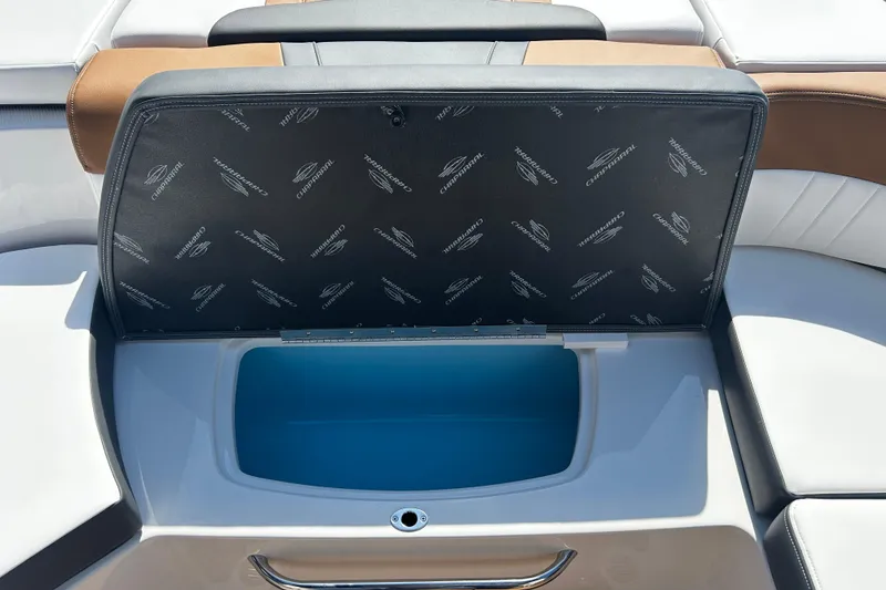 Slide: The Image of 2026 Chaparral 23 SSi OB boat storage compartment with open lid, showcasing interior space. - 22