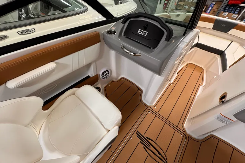 Slide: The Image of 2026 Chaparral 23 SSi OB boat interior at a marine service center. - 6