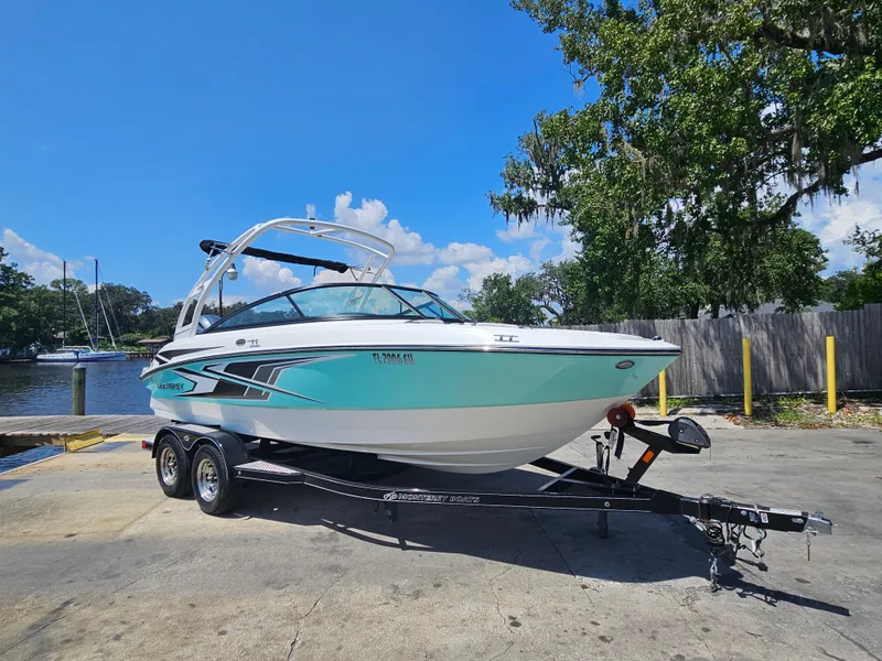 Slide: The Image of 2019 Monterey M-205 boat on trailer, sunny day, harbor in background. - 10