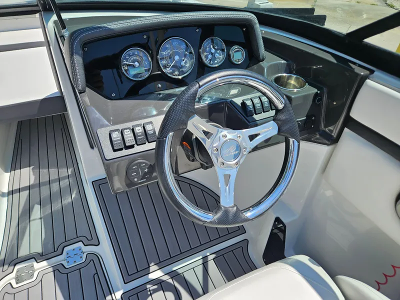 Slide: The Image of Dashboard of a 2019 Monterey M-205 boat with steering wheel and gauges. - 22
