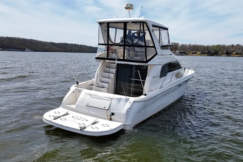 Slide: The Image of 1999 Sea Ray 480 Sedan Bridge yacht on a calm lake. - 19