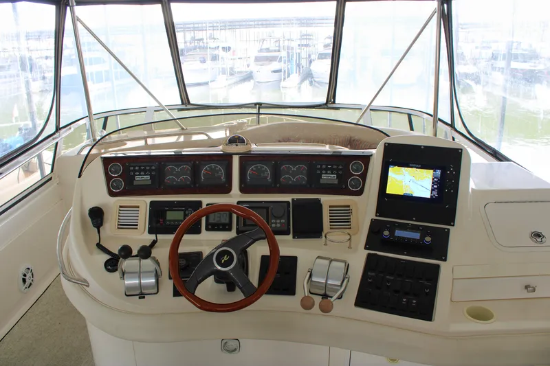 Slide: The Image of Cockpit of 1999 Sea Ray 480 Sedan Bridge with navigation controls and steering wheel. - 20