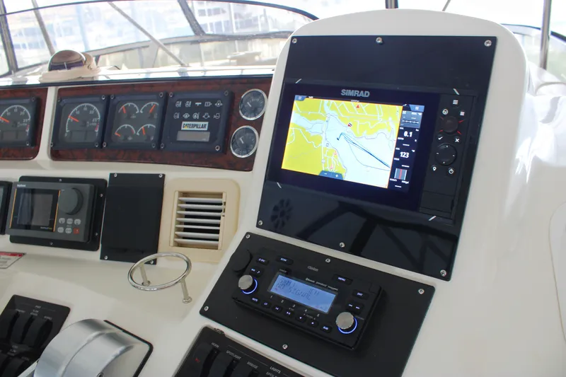 Slide: The Image of 1999 Sea Ray 480 Sedan Bridge dashboard with navigation and control systems. - 21