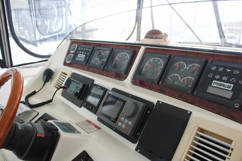 Slide: The Image of Control panel of a 1999 Sea Ray 480 Sedan Bridge yacht with gauges and navigation equipment. - 23