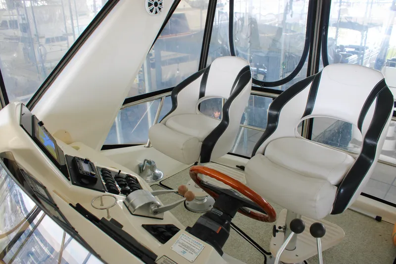 Slide: The Image of Interior helm of 1999 Sea Ray 480 Sedan Bridge with dual captain chairs. - 27
