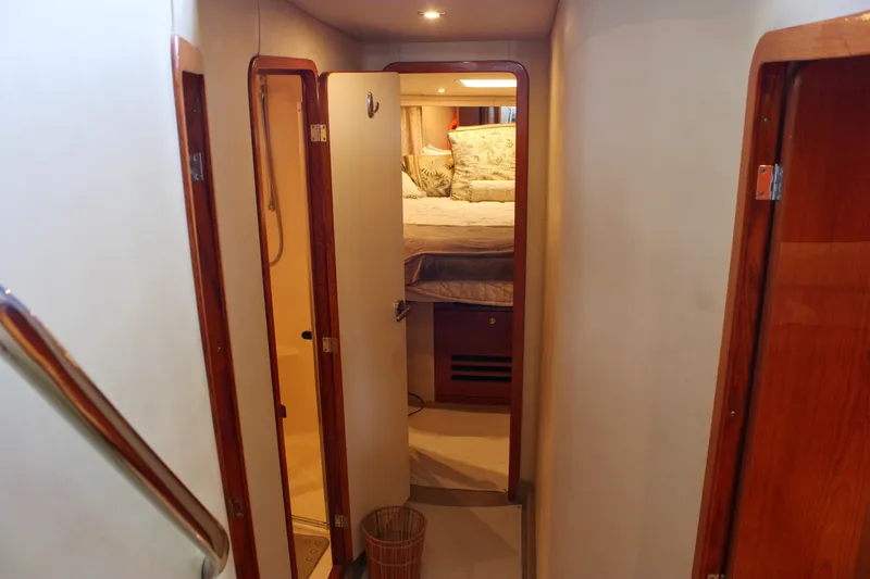 Slide: The Image of Interior hallway of 1999 Sea Ray 480 Sedan Bridge yacht, featuring bedroom and bathroom doors. - 29