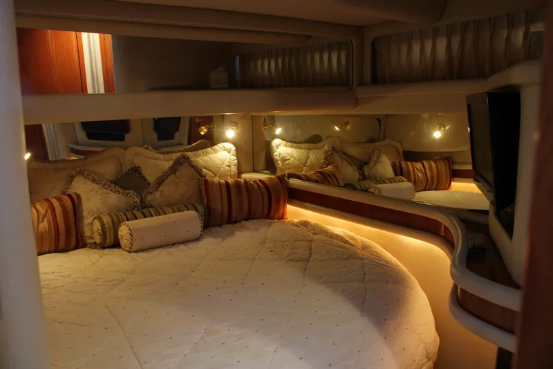 Slide: The Image of Luxurious bedroom interior of 1999 Sea Ray 480 Sedan Bridge yacht with cozy lighting. - 31