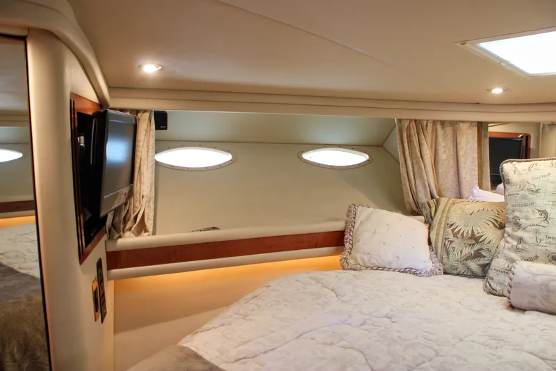 Slide: The Image of Luxurious cabin interior of 1999 Sea Ray 480 Sedan Bridge yacht with cozy bedding. - 34