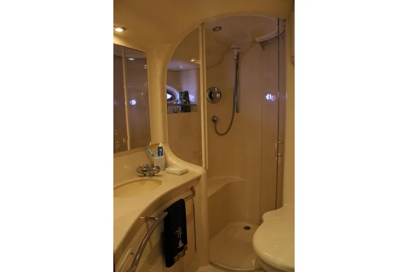 Slide: The Image of Bathroom interior of 1999 Sea Ray 480 Sedan Bridge yacht, featuring shower and sink. - 35