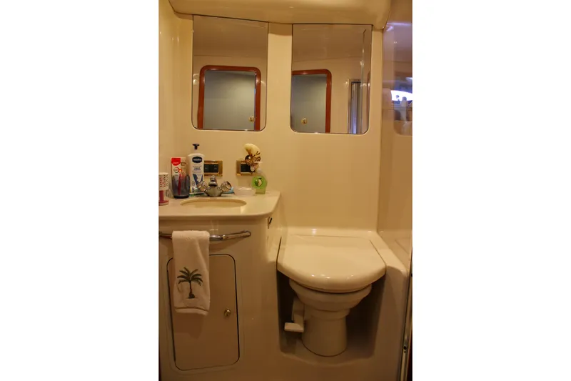 Slide: The Image of Bathroom interior of 1999 Sea Ray 480 Sedan Bridge yacht, featuring sink and toilet. - 36