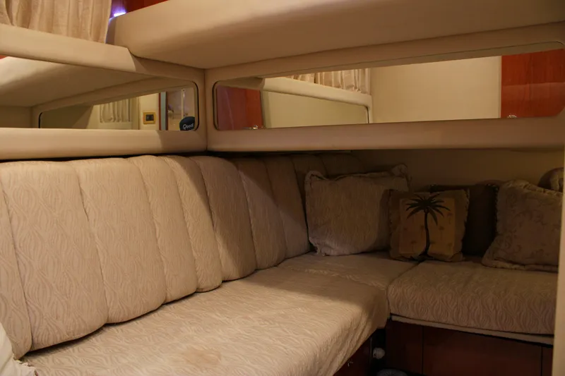 Slide: The Image of Interior of 1999 Sea Ray 480 Sedan Bridge with beige seating and decorative pillows. - 37