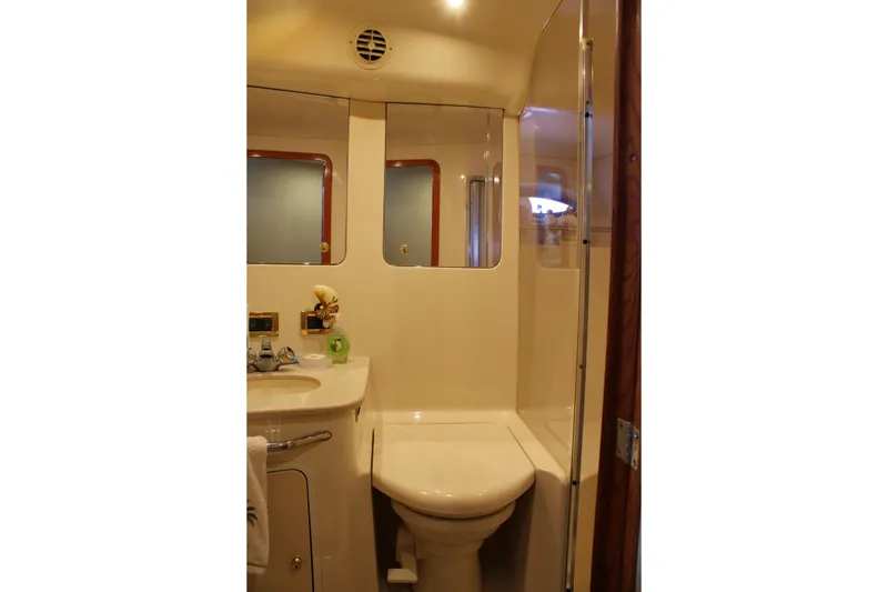 Slide: The Image of Bathroom interior of 1999 Sea Ray 480 Sedan Bridge yacht, featuring sink and shower. - 39