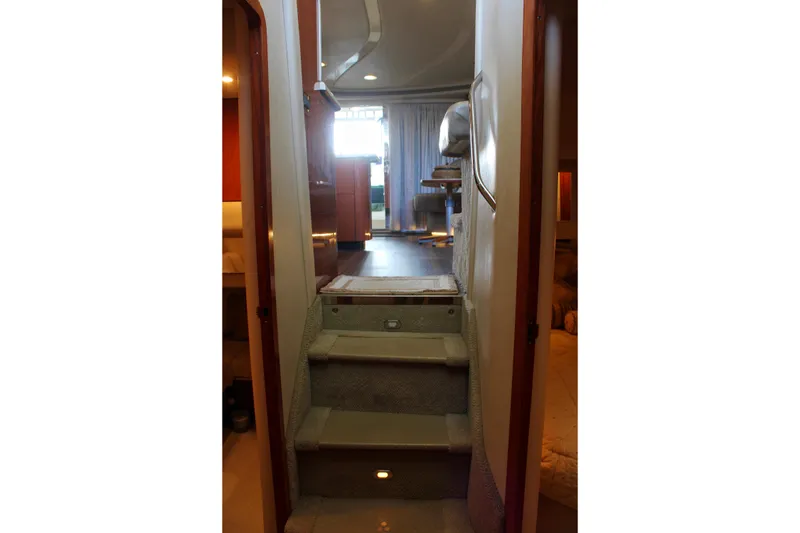 Slide: The Image of Interior view of 1999 Sea Ray 480 Sedan Bridge yacht with carpeted stairs. - 40