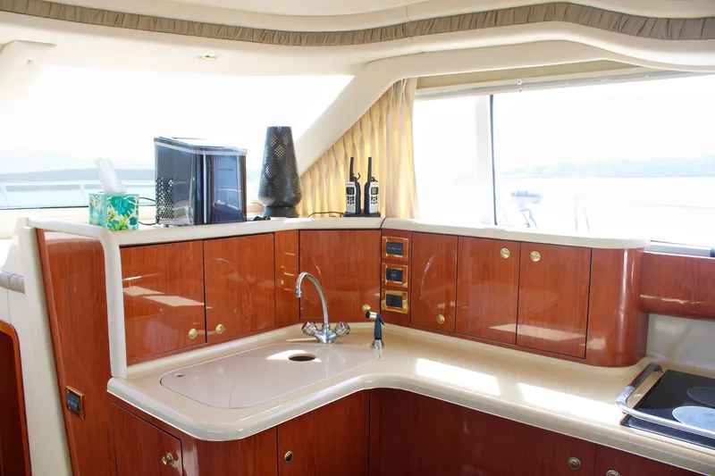 Slide: The Image of Luxurious 1999 Sea Ray 480 Sedan Bridge yacht interior with elegant wood cabinetry and modern amenities. - 42