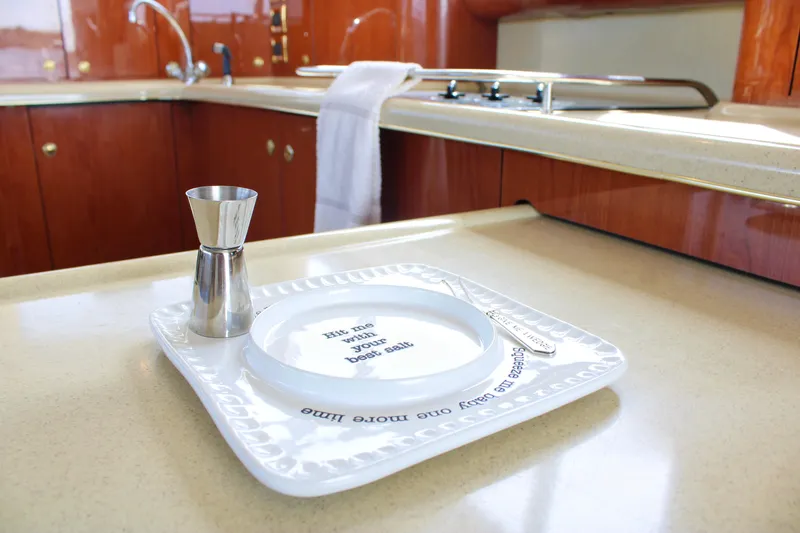 Slide: The Image of Luxurious kitchen interior of 1999 Sea Ray 480 Sedan Bridge yacht with elegant tableware. - 43