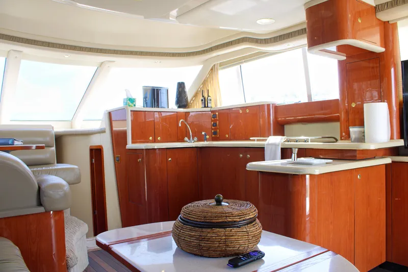 Slide: The Image of Luxurious interior of a 1999 Sea Ray 480 Sedan Bridge yacht with elegant wood finishes. - 49