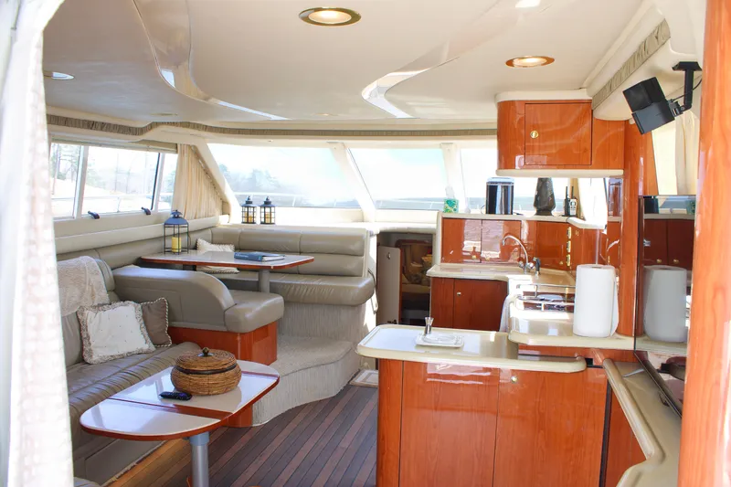 Slide: The Image of Luxurious interior of a 1999 Sea Ray 480 Sedan Bridge yacht with elegant wood finishes. - 50