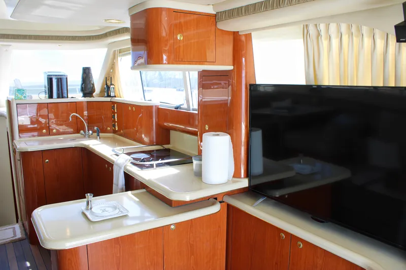 Slide: The Image of Luxurious kitchen interior of 1999 Sea Ray 480 Sedan Bridge yacht with wood cabinetry. - 51