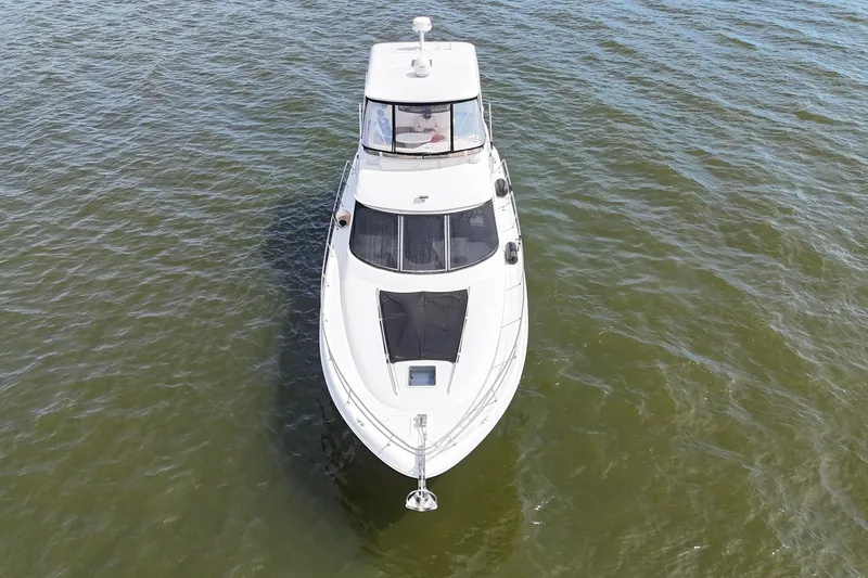 Slide: The Image of 1999 Sea Ray 480 Sedan Bridge yacht on open water, aerial view. - 9