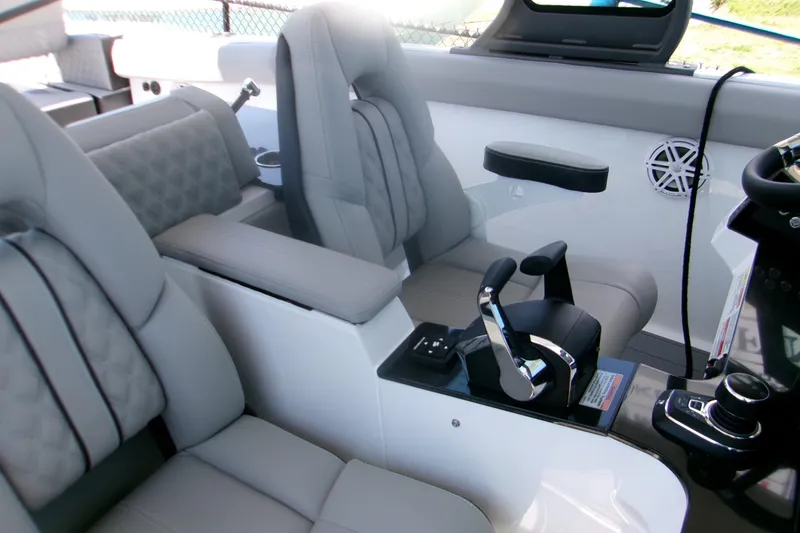 Slide: The Image of Luxurious interior of 2026 Monterey Elite 30 OB boat with modern seating and controls. - 10