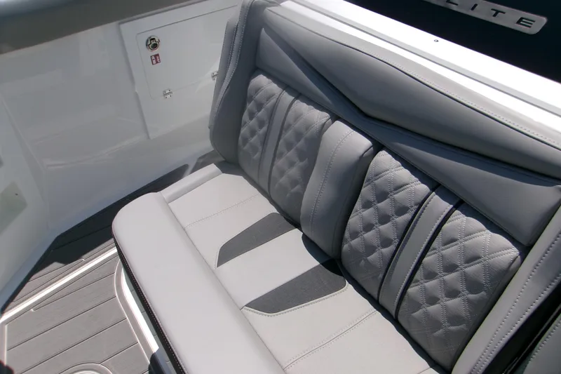 Slide: The Image of Luxurious seating on 2026 Monterey Elite 30 OB boat, featuring quilted gray upholstery. - 12