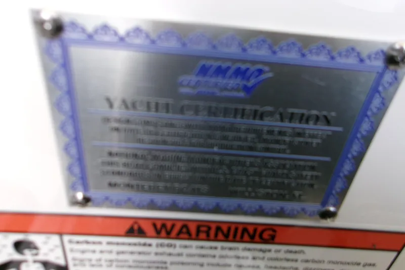 Slide: The Image of Yacht certification plaque for 2026 Monterey Elite 30 OB with warning label. - 15