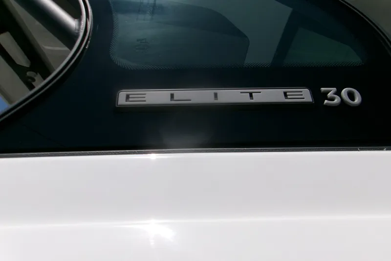 Slide: The Image of 2026 Monterey Elite 30 OB boat emblem close-up with sleek design. - 20