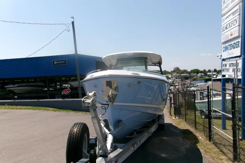 Slide: The Image of 2026 Monterey Elite 30 OB boat on trailer at dealership, sunny day. - 3