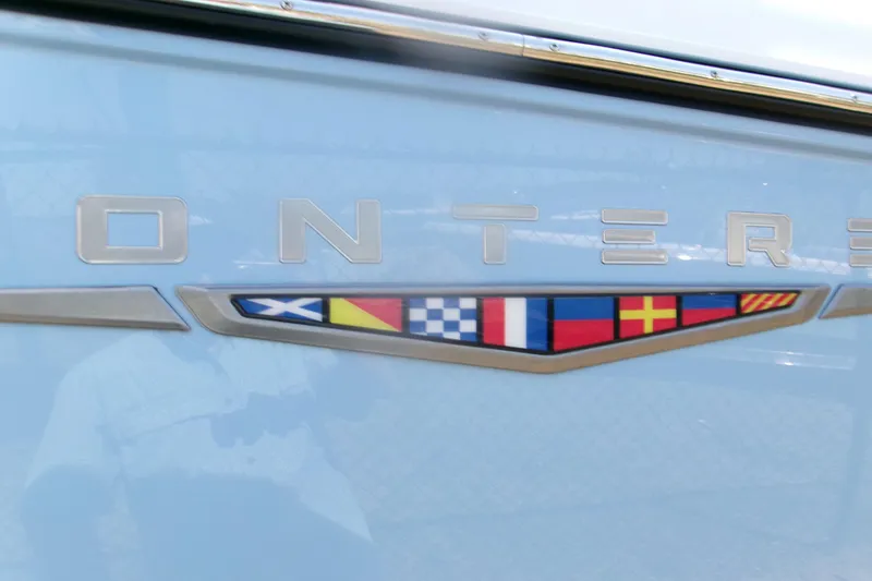 Slide: The Image of Monterey Elite 30 OB 2026 boat emblem with nautical flags on light blue background. - 4