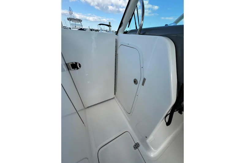 Slide: The Image of 2015 Pursuit DC 265 Dual Console interior with storage compartment and sleek design. - 13