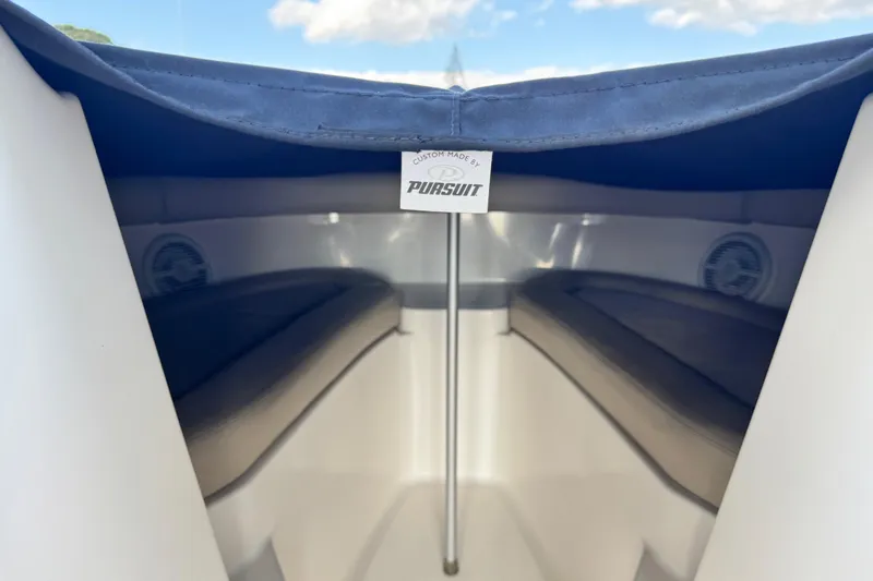 Slide: The Image of Interior view of a 2015 Pursuit DC 265 Dual Console boat with seating and cover. - 14