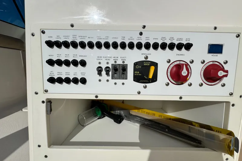 Slide: The Image of Control panel of a 2015 Pursuit DC 265 Dual Console boat with switches and dials. - 5