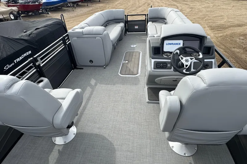 Slide: The Image of 2024 Regency 250 DL3 pontoon boat interior with plush seating and modern helm controls. - 12