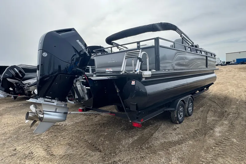 Slide: The Image of 2024 Regency 250 DL3 pontoon boat with Mercury outboard engine on a trailer. - 3