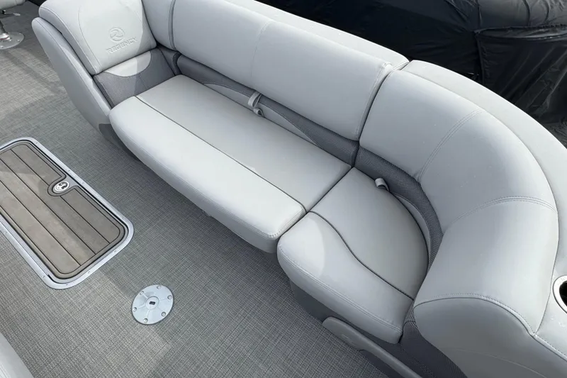 Slide: The Image of 2024 Regency 250 DL3 boat interior with plush gray seating and deck flooring. - 5