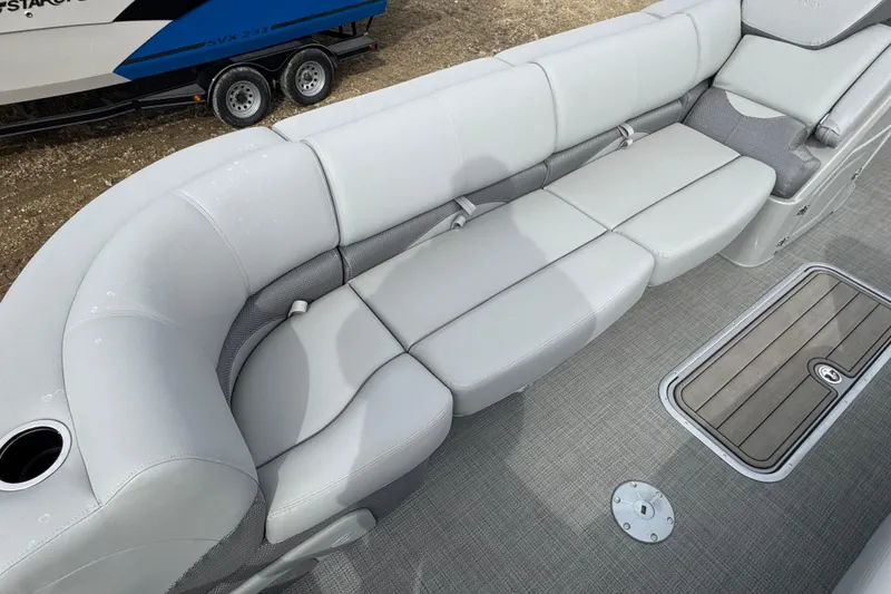 Slide: The Image of 2024 Regency 250 DL3 boat interior with plush seating and modern flooring. - 6