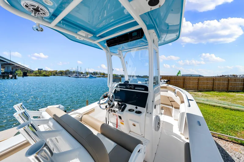 Slide: The Image of 2023 Everglades 243 Center Console boat docked by a scenic waterfront. - 15