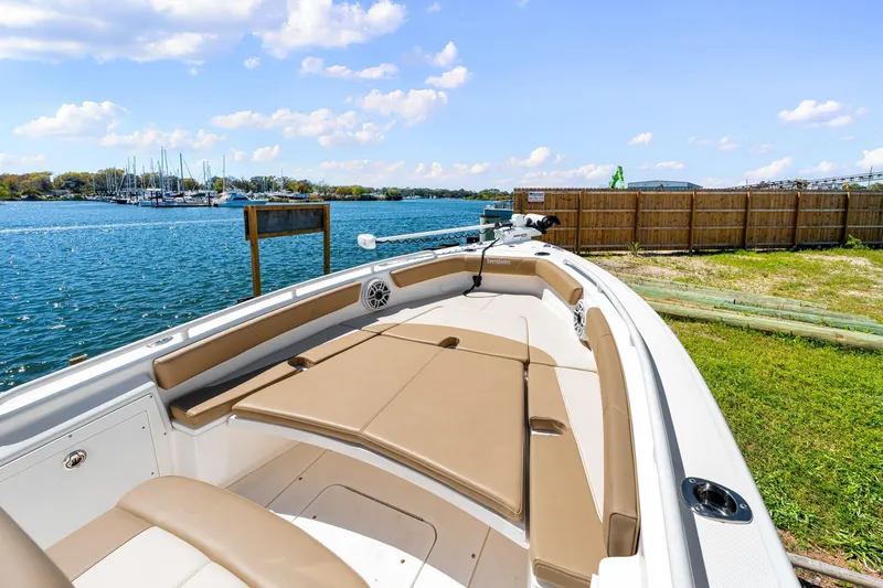 Slide: The Image of 2023 Everglades 243 Center Console boat docked by a scenic waterfront. - 18