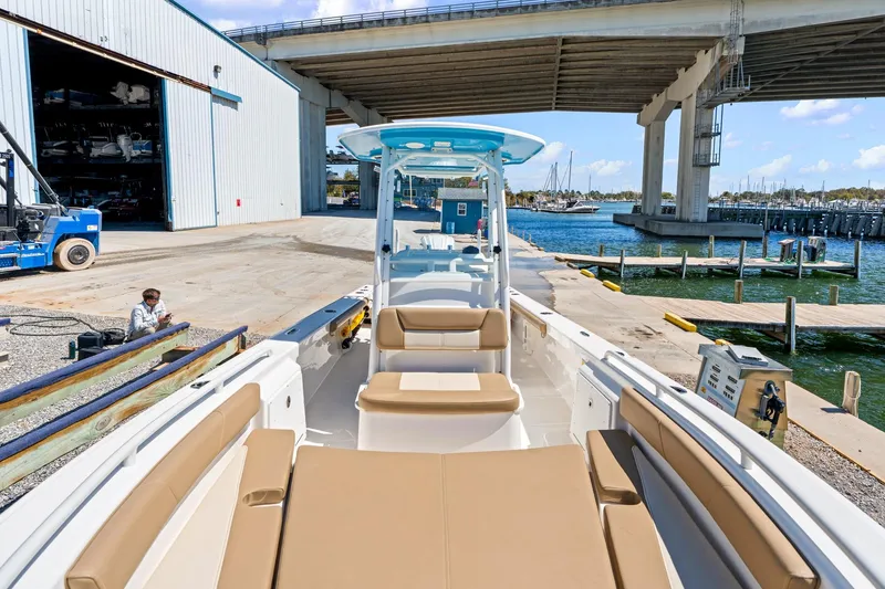 Slide: The Image of 2023 Everglades 243 Center Console boat docked near marina under bridge. - 20